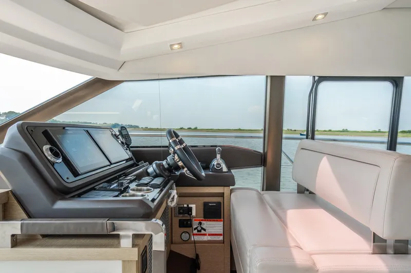 Yore Amuche Yacht Photos Pics Interior of 2019 Prestige 520S yacht showing helm station and seating area.
