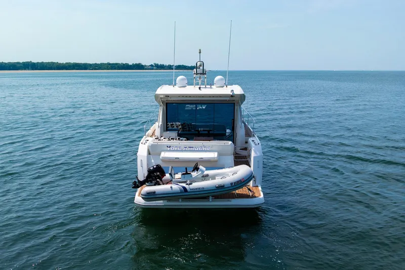 Yore Amuche Yacht Photos Pics 2019 Prestige 520S yacht on calm water with inflatable boat at stern.
