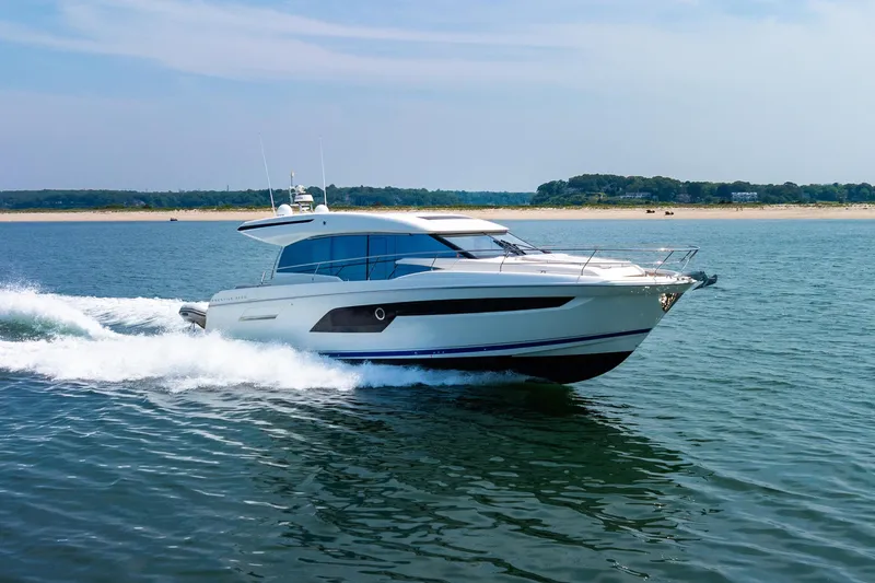 Yore Amuche Yacht Photos Pics 2019 Prestige 520S yacht cruising on open water near a sandy shoreline.