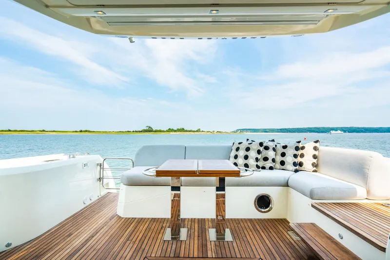 Yore Amuche Yacht Photos Pics Luxurious 2019 Prestige 520S yacht deck with seating, table, and scenic water view.