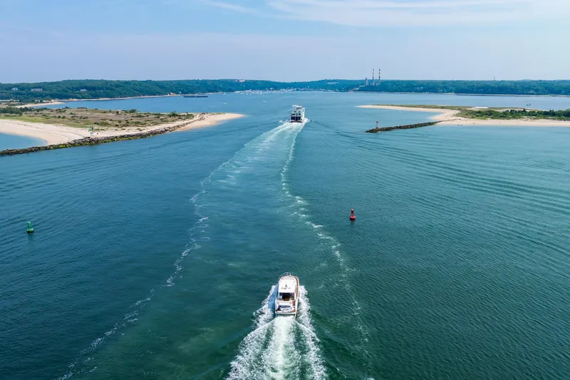 Yore Amuche Yacht Photos Pics Aerial view of a 2019 Prestige 520S yacht cruising through a scenic waterway.