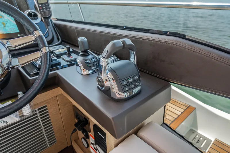 Yore Amuche Yacht Photos Pics Control panel of a 2019 Prestige 520S yacht with steering wheel and throttle.