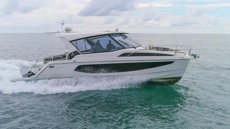  Yacht Photos Pics 2023 Aquila 36 Sport cruising on open water under a cloudy sky.