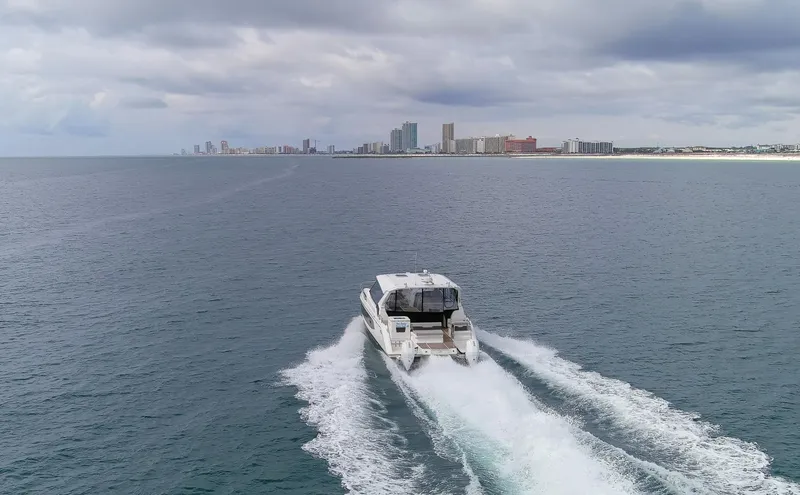  Yacht Photos Pics Aquila 36 Sport 2023 cruising on open water with city skyline in background.