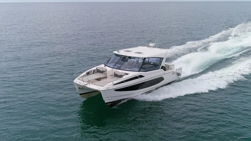  Yacht Photos Pics 2023 Aquila 36 Sport yacht cruising on open water.