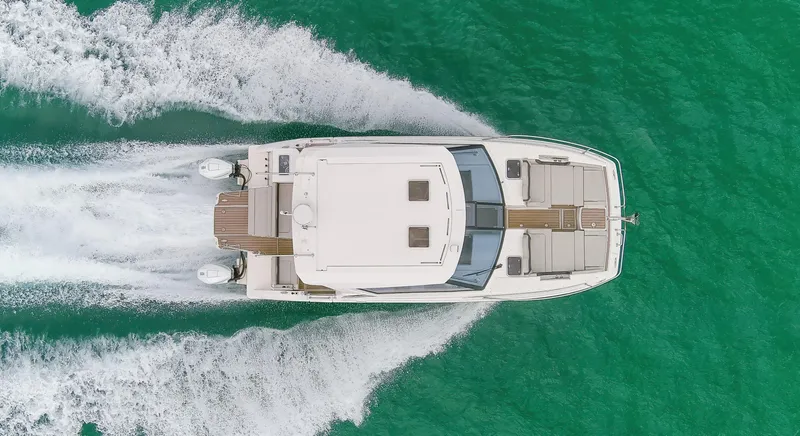  Yacht Photos Pics Aquila 36 Sport 2023 cruising on turquoise water, aerial view.