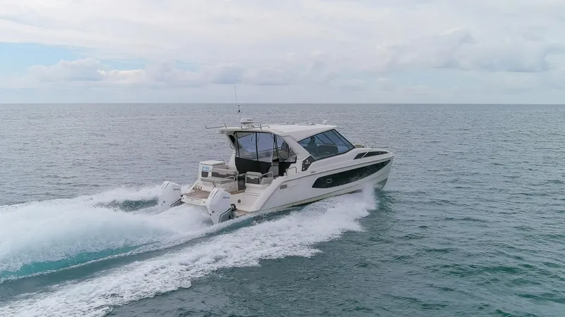  Yacht Photos Pics 2023 Aquila 36 Sport cruising on open water under a cloudy sky.