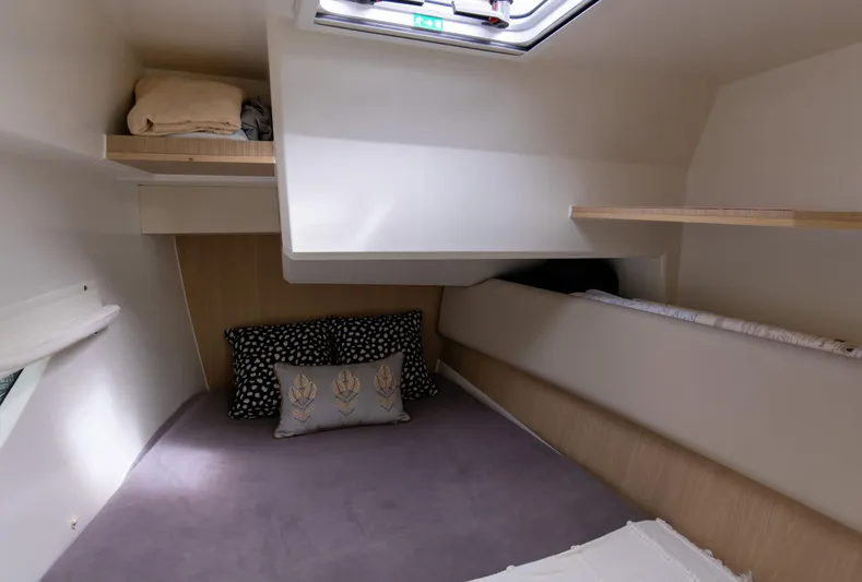  Yacht Photos Pics Cozy cabin interior of 2023 Aquila 36 Sport with bedding and storage shelves.