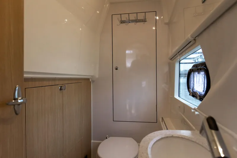  Yacht Photos Pics 2023 Aquila 36 Sport yacht bathroom with modern fixtures and wooden cabinetry.