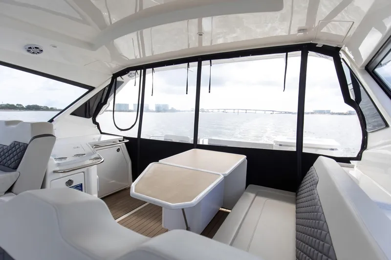  Yacht Photos Pics Interior of 2023 Aquila 36 Sport yacht with seating and table, overlooking water.
