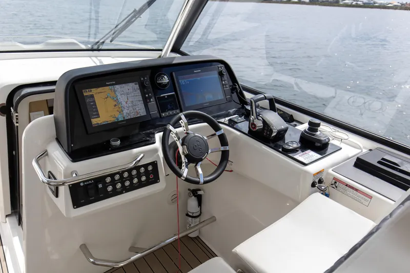 Yacht Photos Pics Cockpit of 2023 Aquila 36 Sport boat with navigation screens and controls.