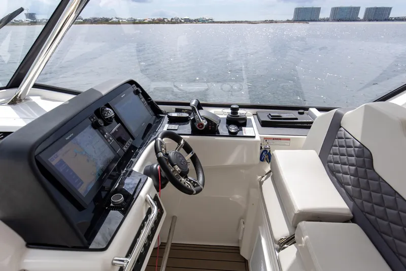  Yacht Photos Pics Interior view of 2023 Aquila 36 Sport boat cockpit with modern controls and steering.