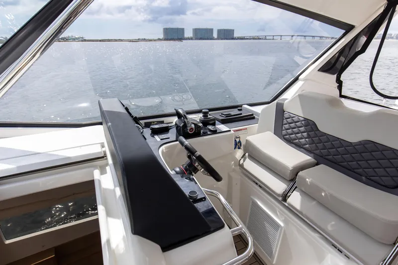  Yacht Photos Pics Interior view of 2023 Aquila 36 Sport yacht helm with modern controls and seating.