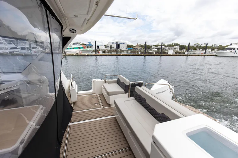  Yacht Photos Pics 2023 Aquila 36 Sport yacht deck with seating, docked at marina.