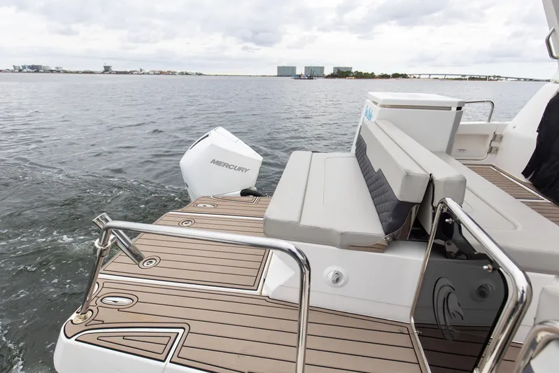  Yacht Photos Pics 2023 Aquila 36 Sport boat with Mercury engine, featuring sleek deck and seating area.