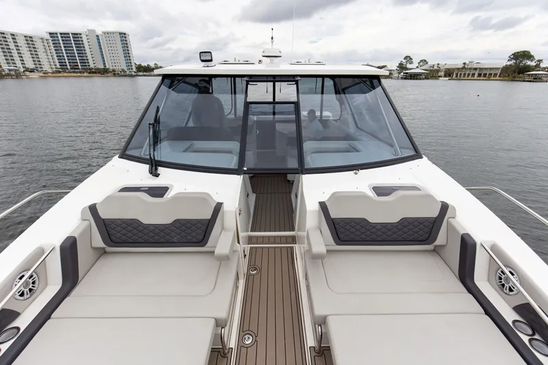  Yacht Photos Pics 2023 Aquila 36 Sport boat with spacious seating and modern design on a calm waterway.