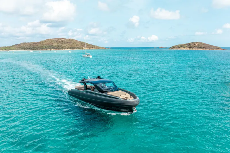 V-adeus Yacht Photos Pics 2024 SACS Rebel 55 yacht cruising in turquoise waters near scenic islands.