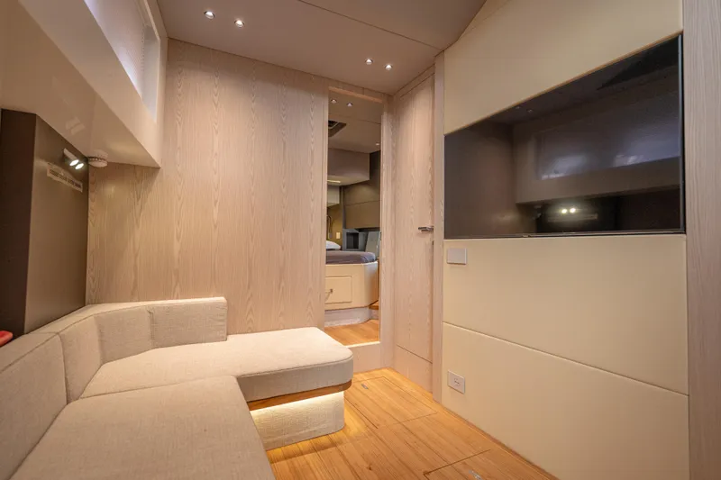V-adeus Yacht Photos Pics Luxurious interior of 2024 SACS Rebel 55 yacht with modern seating and wood finishes.