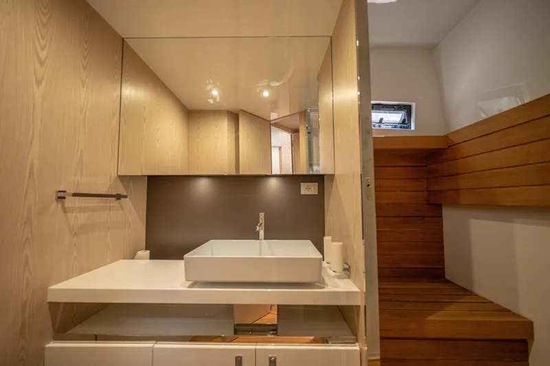 V-adeus Yacht Photos Pics Modern bathroom interior on 2024 SACS Rebel 55 yacht, featuring sleek design and wooden accents.