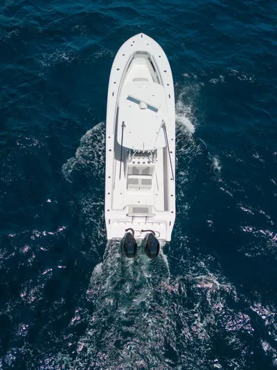  Yacht Photos Pics Aerial view of 2025 Front Runner 33 CC Custom boat cruising on blue ocean waters.