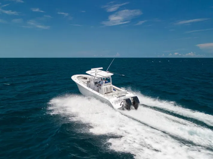  Yacht Photos Pics 2025 Front Runner 33 CC Custom boat cruising on open ocean under clear blue sky.