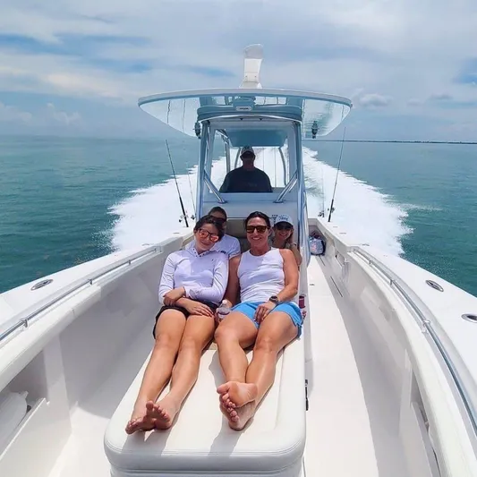  Yacht Photos Pics People relaxing on a 2025 Front Runner 33 CC Custom boat cruising on the ocean.