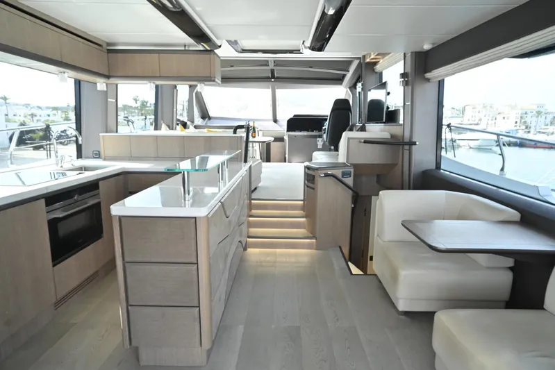  Yacht Photos Pics Luxurious interior of 2021 Galeon 680 Fly yacht with modern kitchen and seating area.