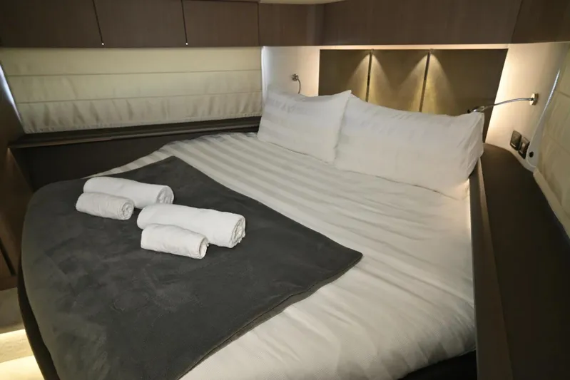  Yacht Photos Pics Luxurious bedroom interior of 2021 Galeon 680 Fly yacht with neatly arranged towels.