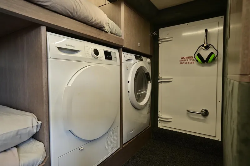  Yacht Photos Pics Laundry area inside a 2021 Galeon 680 Fly yacht, featuring modern appliances.