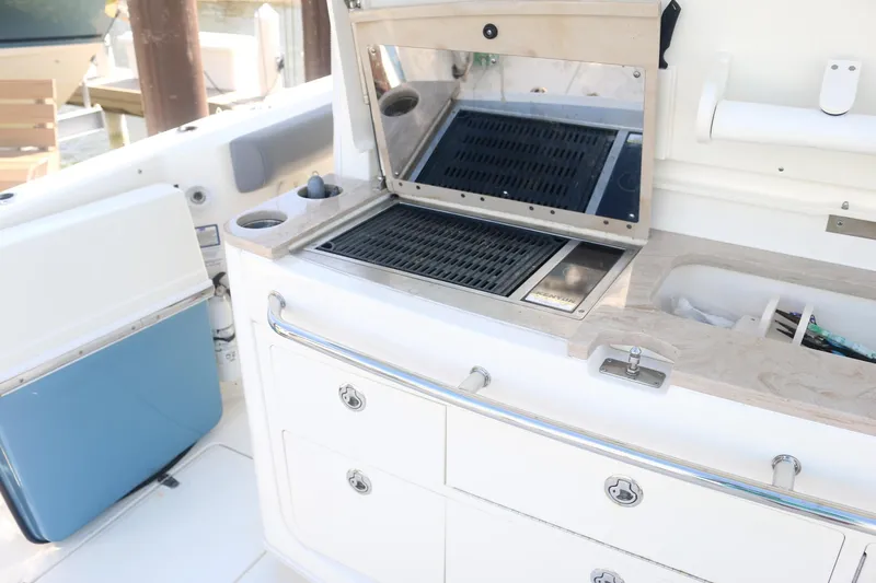  Yacht Photos Pics Boston Whaler 380 Outrage 2022 boat kitchen with grill and storage drawers.