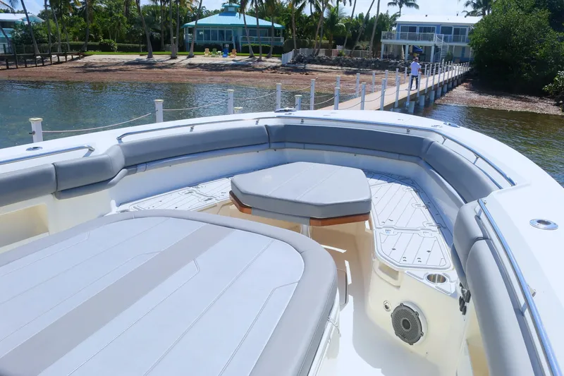  Yacht Photos Pics Boston Whaler 380 Outrage 2022 boat with spacious seating and scenic dock view.