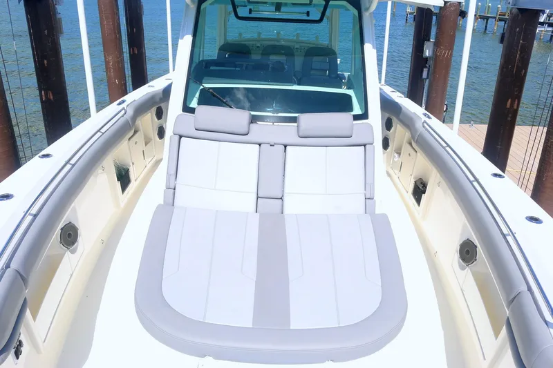  Yacht Photos Pics 2022 Boston Whaler 380 Outrage boat interior with cushioned seating and ocean view.