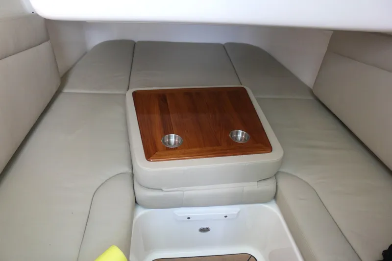  Yacht Photos Pics Interior cabin of 2022 Boston Whaler 380 Outrage with cushioned seating and wooden table.