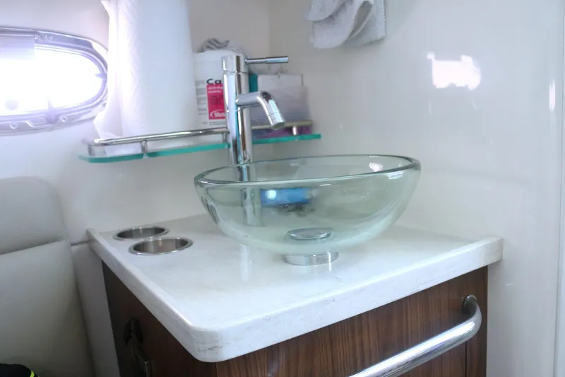  Yacht Photos Pics 2022 Boston Whaler 380 Outrage bathroom with glass sink and modern faucet.