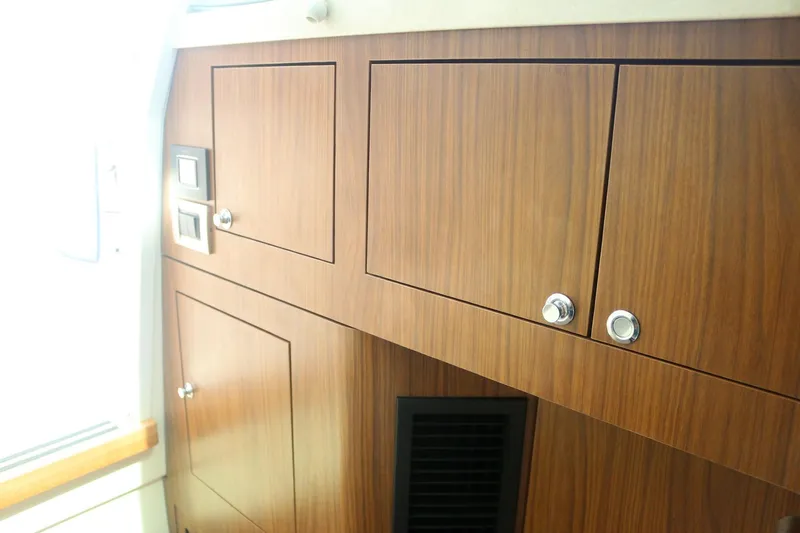  Yacht Photos Pics Interior cabinetry of 2022 Boston Whaler 380 Outrage, featuring sleek wooden finish and modern design.