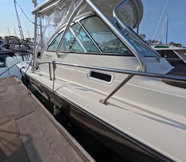 Alibi Yacht Photos Pics 2006 Rampage Express Offshore Tower boat docked at marina, showcasing sleek design and sturdy build.