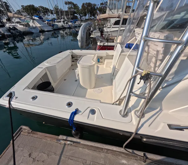 Alibi Yacht Photos Pics 2006 Rampage Express Offshore Tower boat docked at marina, featuring spacious deck and ladder.