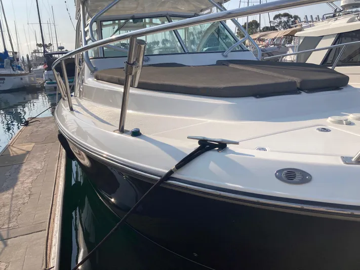 Alibi Yacht Photos Pics 2006 Rampage Express Offshore Tower boat docked at marina, side view.