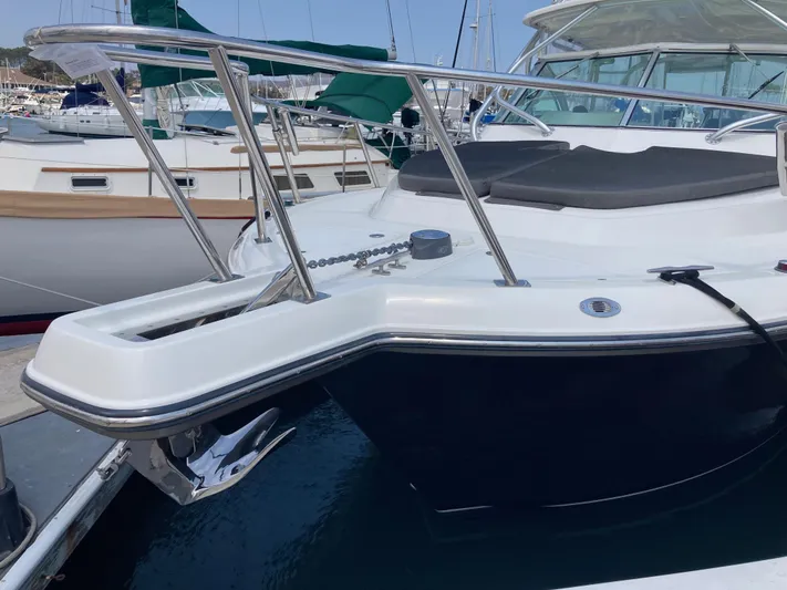 Alibi Yacht Photos Pics 2006 Rampage Express Offshore Tower boat docked in marina, featuring sleek design and stainless steel railings.