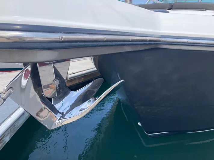 Alibi Yacht Photos Pics 2006 Rampage Express Offshore Tower boat with shiny anchor in marina.