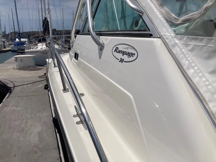 Alibi Yacht Photos Pics 2006 Rampage Express Offshore Tower boat docked at marina.