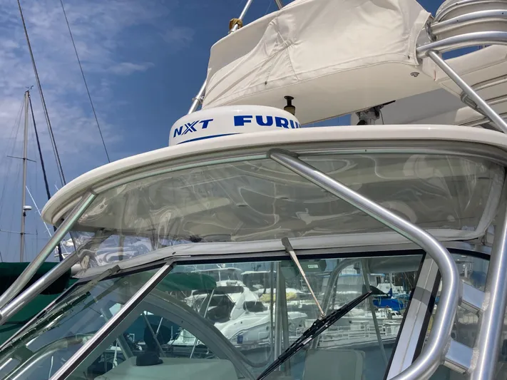 Alibi Yacht Photos Pics 2006 Rampage Express Offshore Tower boat with radar, docked at marina.