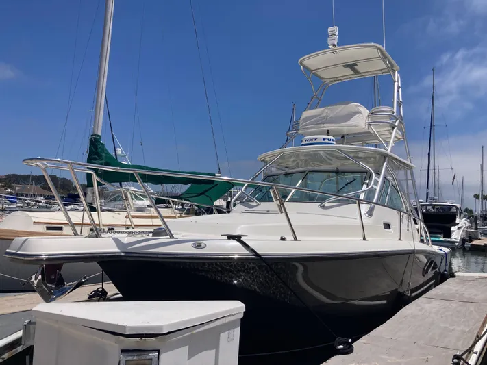 Alibi Yacht Photos Pics 2006 Rampage Express Offshore Tower yacht docked at marina under clear blue sky.