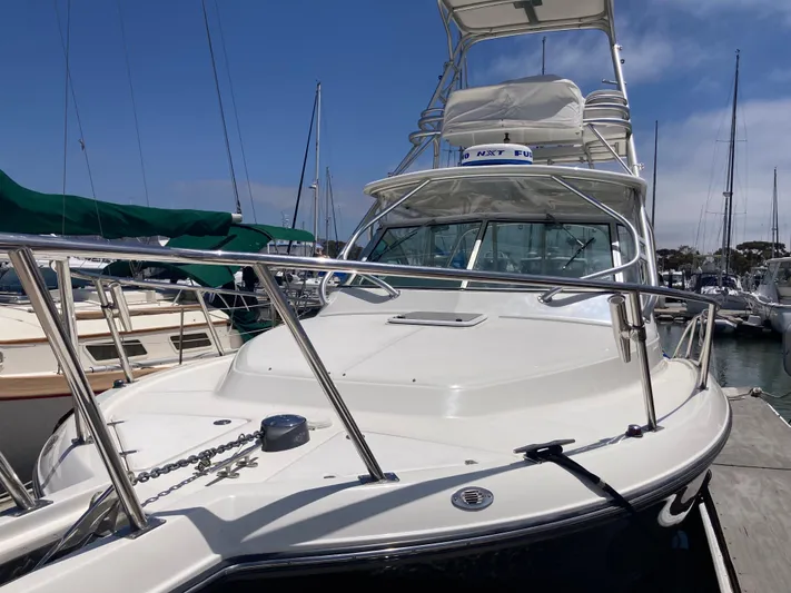 Alibi Yacht Photos Pics 2006 Rampage Express Offshore Tower boat docked at marina under clear blue sky.