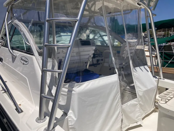 Alibi Yacht Photos Pics 2006 Rampage Express Offshore Tower boat with clear enclosure and ladder.