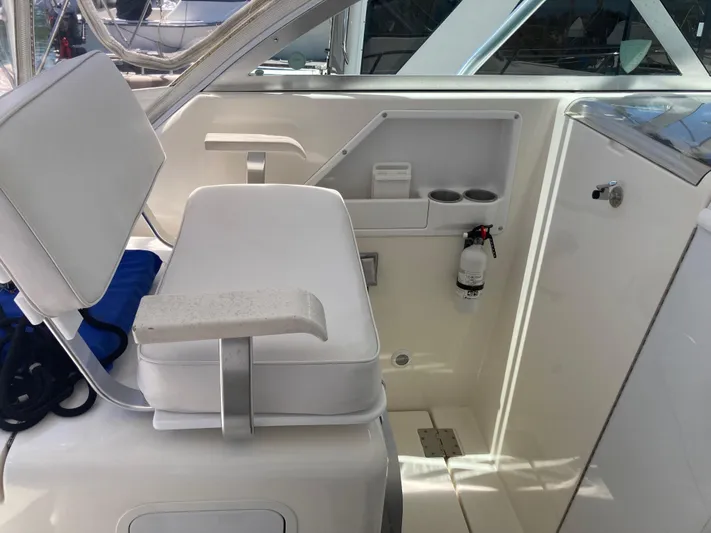 Alibi Yacht Photos Pics 2006 Rampage Express Offshore Tower boat interior with white seating and storage compartments.