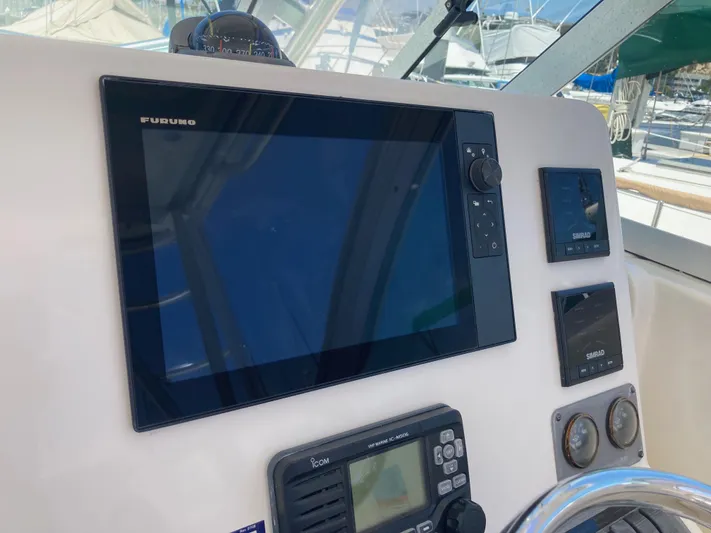 Alibi Yacht Photos Pics 2006 Rampage Express Offshore Tower dashboard with Furuno and Simrad navigation equipment.