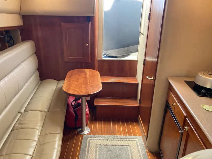 Alibi Yacht Photos Pics Interior of 2006 Rampage Express Offshore Tower with leather seating and wooden finishes.