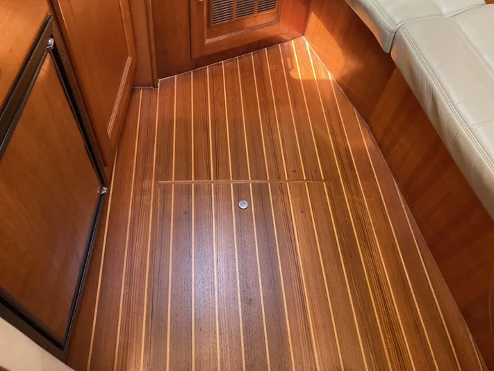 Alibi Yacht Photos Pics Teak wood flooring inside 2006 Rampage Express Offshore Tower boat cabin.