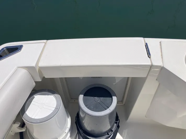 Alibi Yacht Photos Pics 2006 Rampage Express Offshore Tower boat deck with storage compartments and buckets.